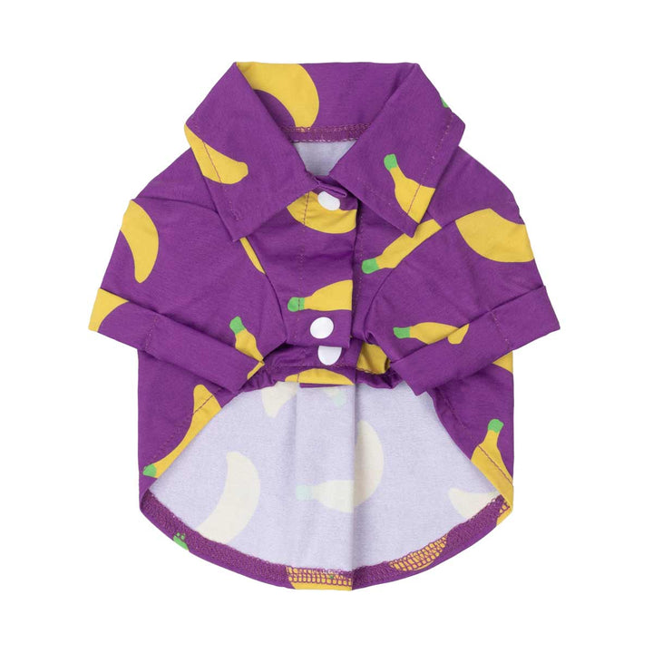 Purple dog shirt with banana pattern on a white background