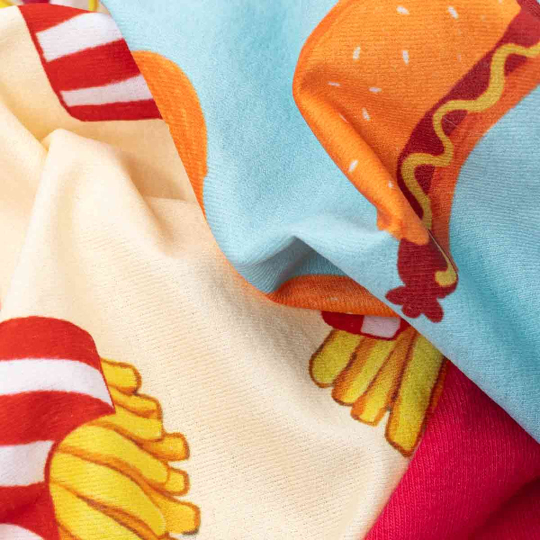Close-up of colorful fabric with cartoon-like designs on a textured surface.
