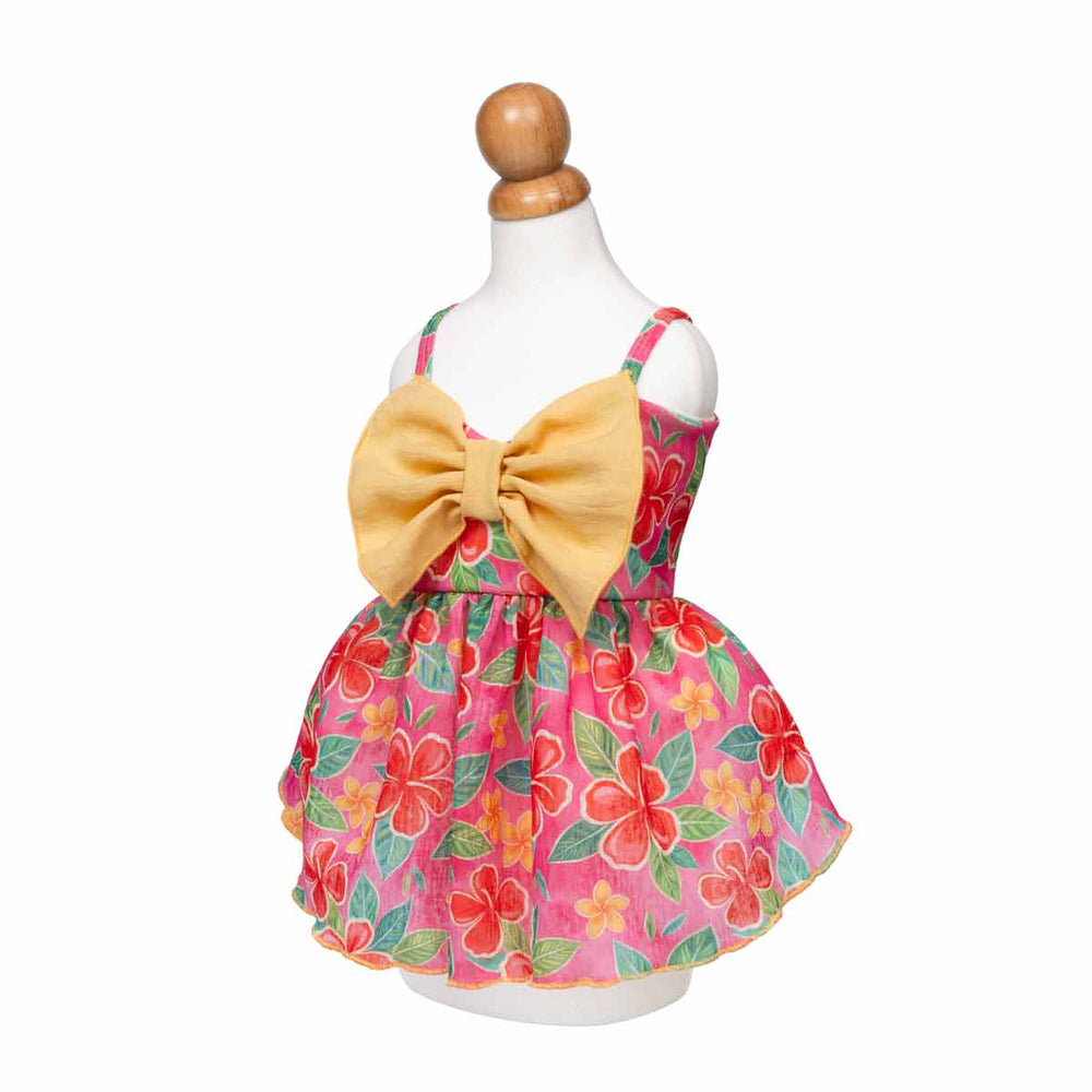 Floral dog Hawaiian dress with a large yellow bow on a mannequin against a white background