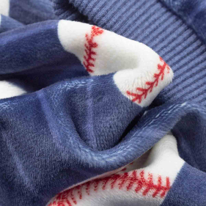 Close-up of blue and white dog pjs with baseball prints.
