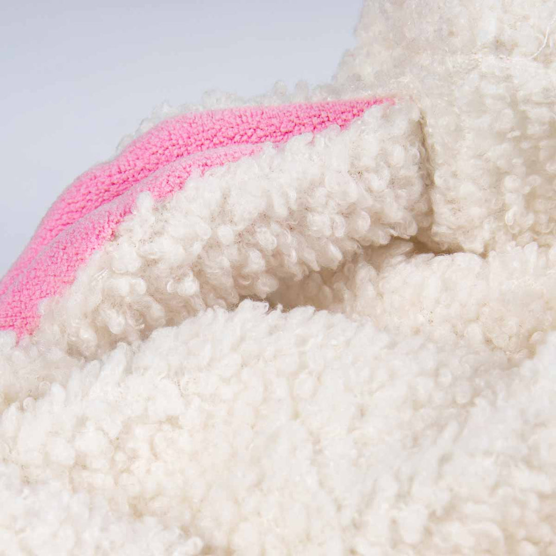 Soft white polyester and pink ear fabric detail of a cozy lamb dog Halloween outfit.