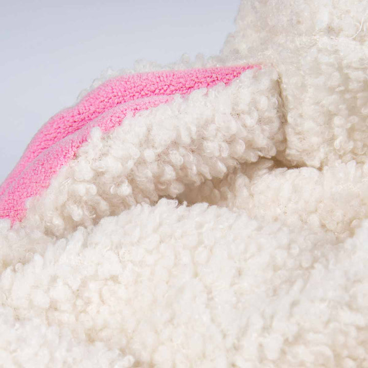 Soft white polyester and pink ear fabric detail of a cozy lamb dog Halloween outfit.