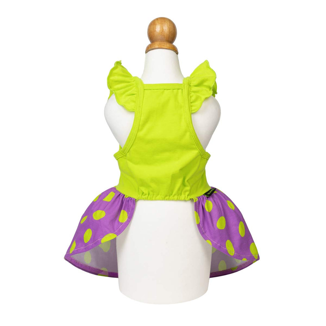 Spooky dog Halloween dress displayed on a white mannequin, featuring a bright lime green ruffled top and a flared purple skirt with lime green polka dots