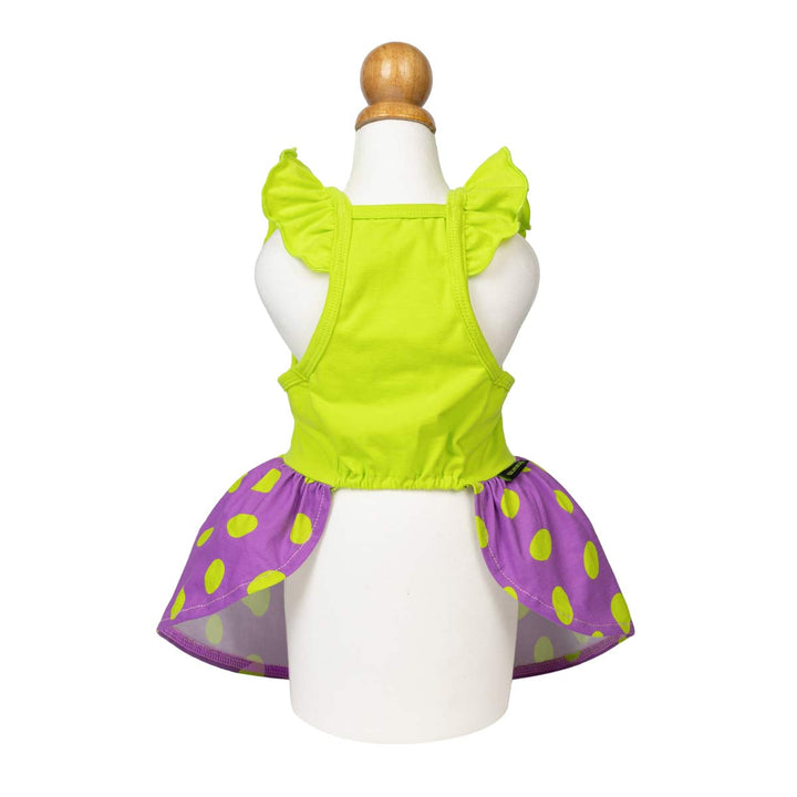 Spooky dog Halloween dress displayed on a white mannequin, featuring a bright lime green ruffled top and a flared purple skirt with lime green polka dots