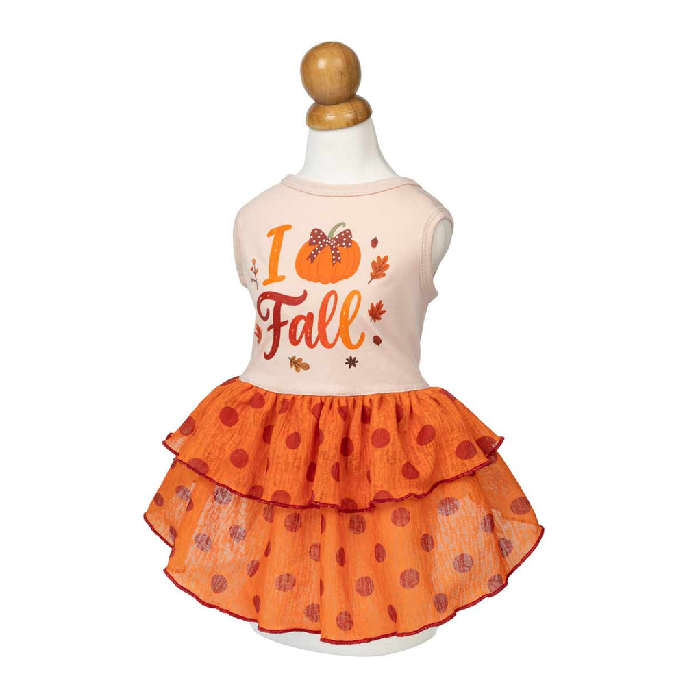 Thankgiving dress for dogs displayed on a mannequin, featuring a light peach top with a 'I Fall' autumn graphic and a tiered orange skirt with red polka dots