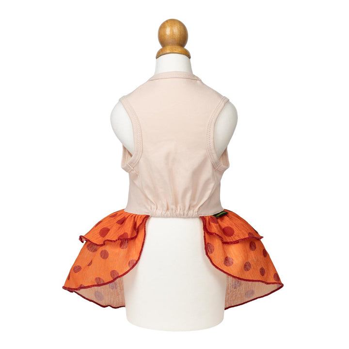 Sweet dog Thanksgiving tutu displayed on a white mannequin from the back, featuring a gathered orange ruffled skirt with red polka dots and a dark red trim