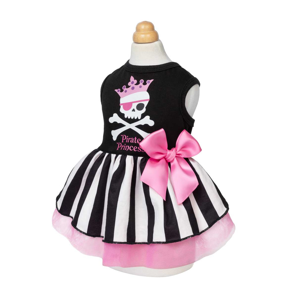 Spooky dog Halloween dress displayed on a mannequin, featuring a pink and white pirate skull graphic on the chest, a black and white striped tutu skirt, and a large pink bow on the side
