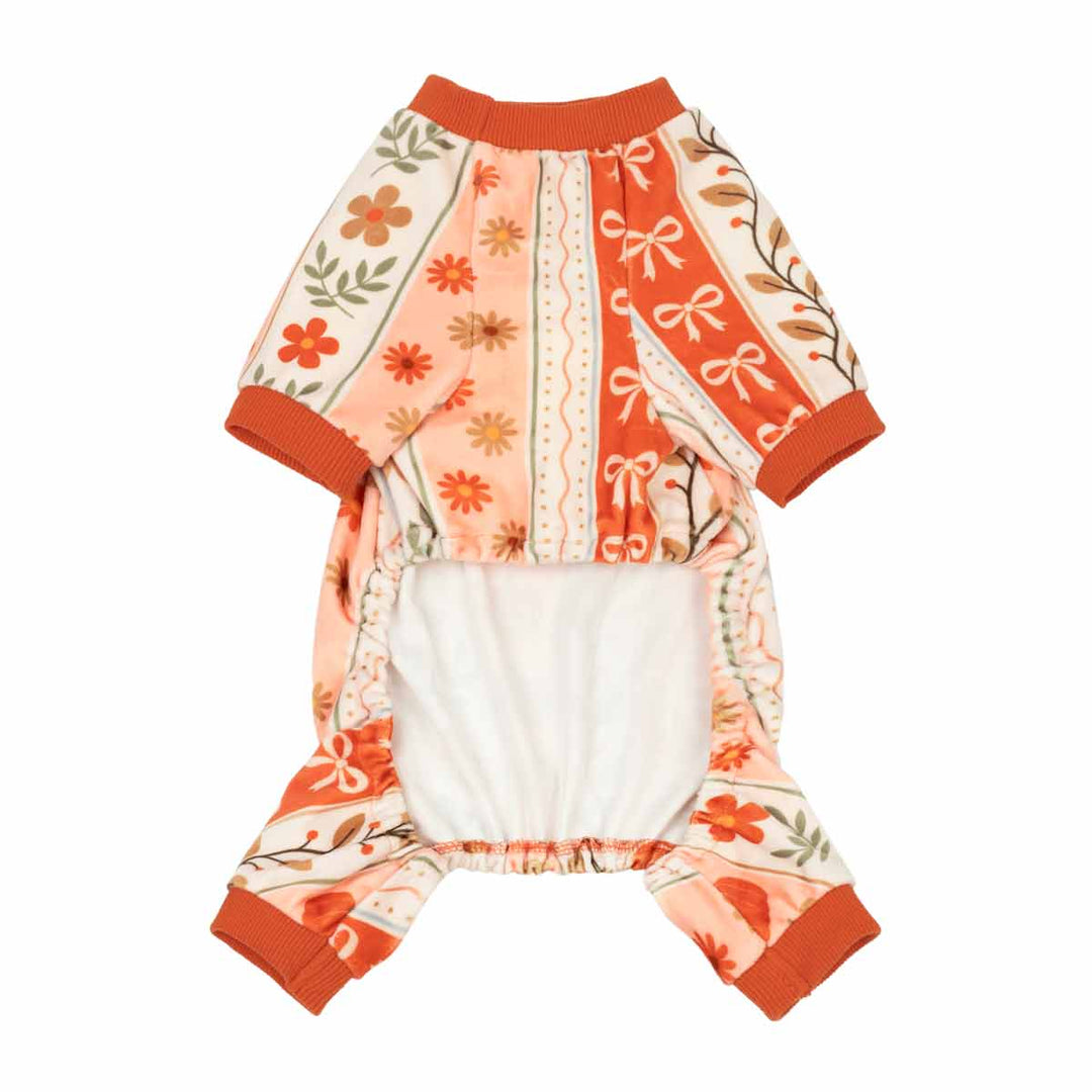 Thanksgiving dog pajamas or with a retro floral and bow pattern in orange, peach, and cream, featuring a solid white inner lining