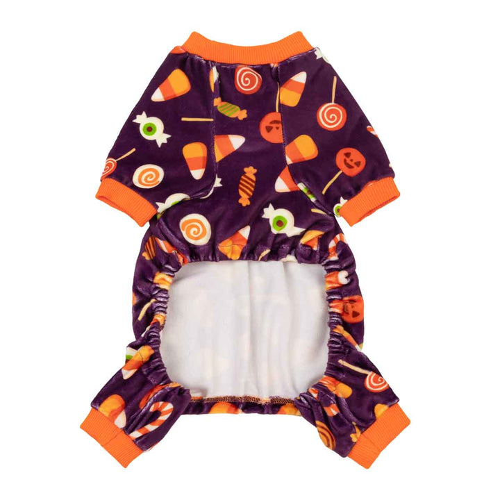 Plush purple Halloween dog PJs with candy corn, lollipop, and jack-o'-lantern prints; orange cuffs.