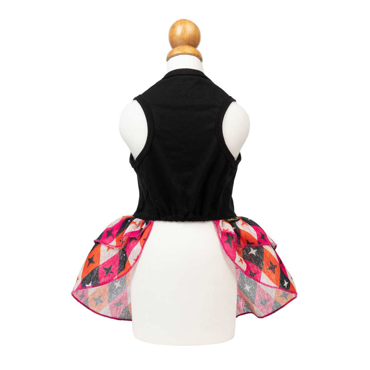 Sleeveless black dog Halloween dress displayed from the back, featuring a vibrant, multicolored ruffled skirt with geometric patterns in pink, orange, black, and white