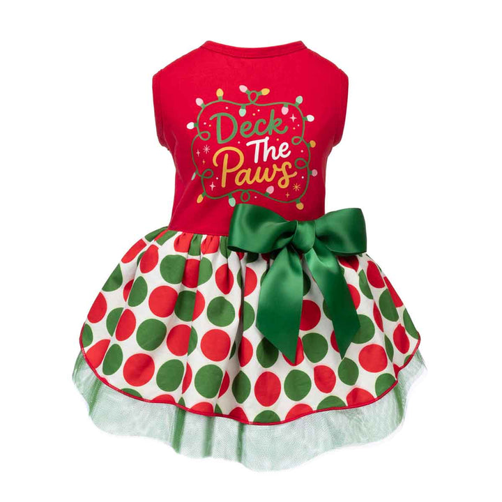 Festive Christmas-themed dress for dogs with a bright red sleeveless top featuring the lettering 'Deck The Paws' in green and yellow, paired with a white skirt
