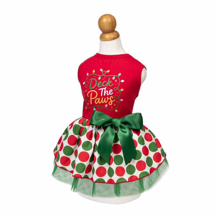 Christmas dog dress displayed on a mannequin torso against a white background. The dress has a bright red sleeveless top with the text 'Duck The Paws' in gold and white, and a white tutu skirt