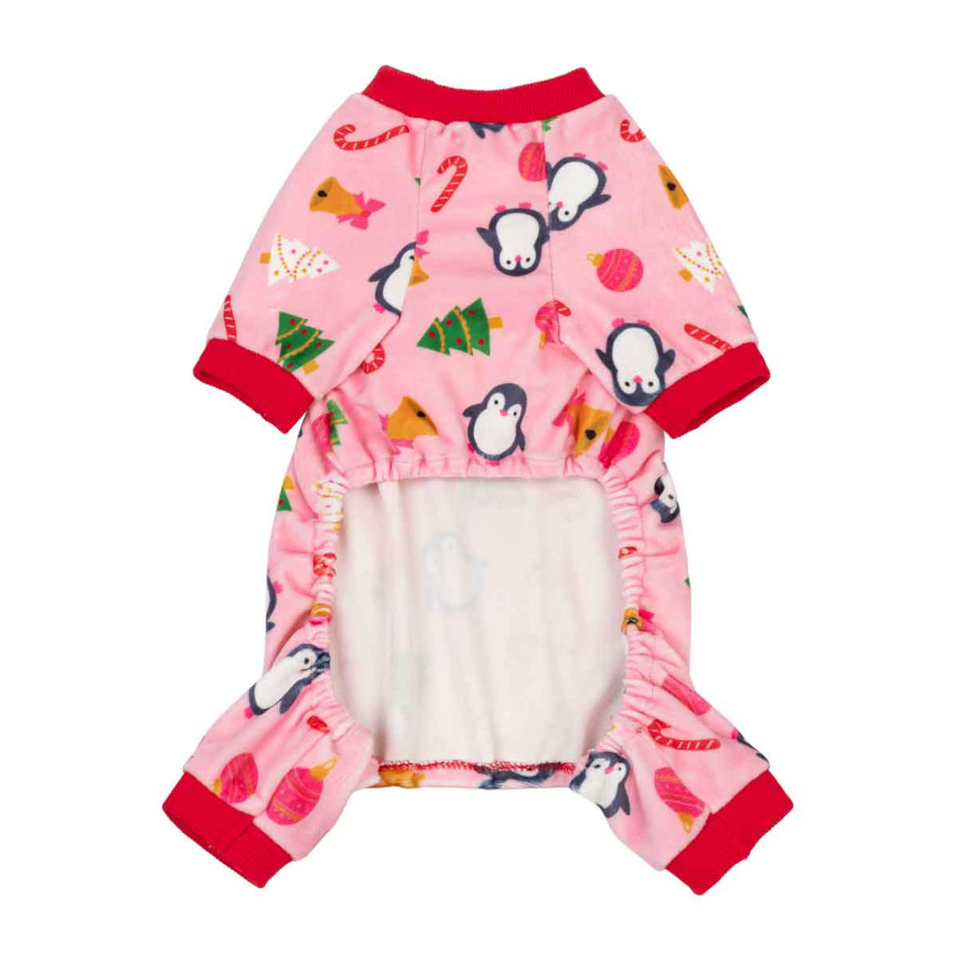 Pink dog onesi with a penguin and holiday print, featuring red cuffs and a white underpajama layer visible at the front opening