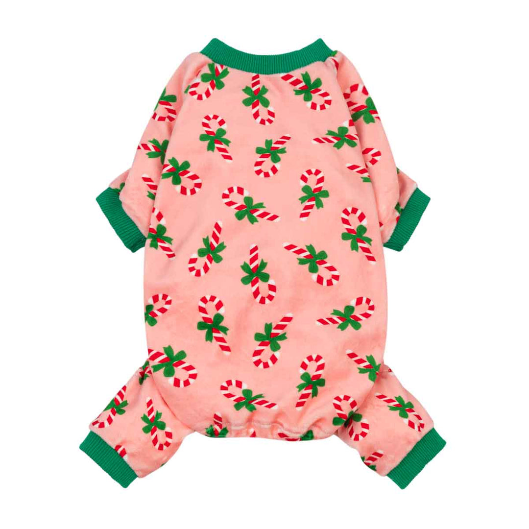 Pink dog pajamas with candy cane print and green trim.
