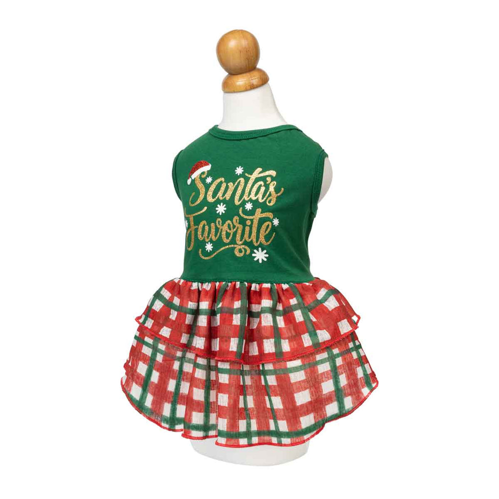 Festive dog Christmas dress with 'Santa's Favorite' lettering and plaid skirt displayed on a mannequin torso against a white background