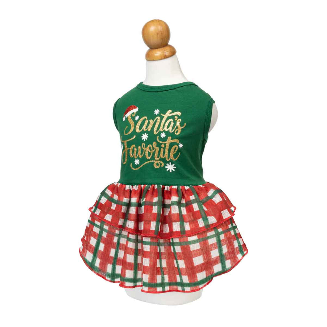 Festive dog Christmas dress with 'Santa's Favorite' lettering and plaid skirt displayed on a mannequin torso against a white background