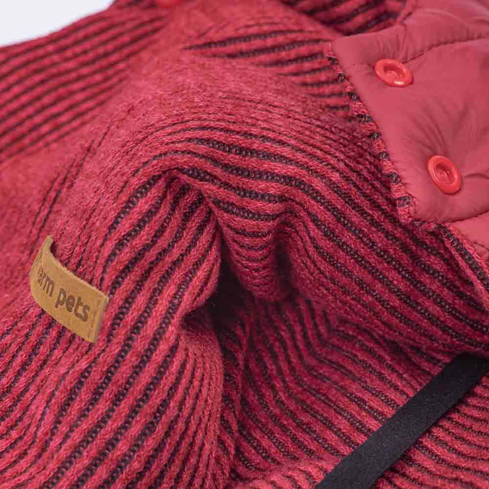 Berry red reversible dog coat: close up of textured knit with stripes and quilted puffer side with buttons.