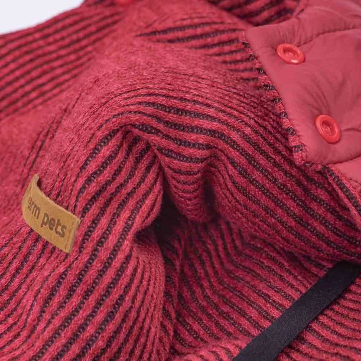 Berry red reversible dog coat: close up of textured knit with stripes and quilted puffer side with buttons.