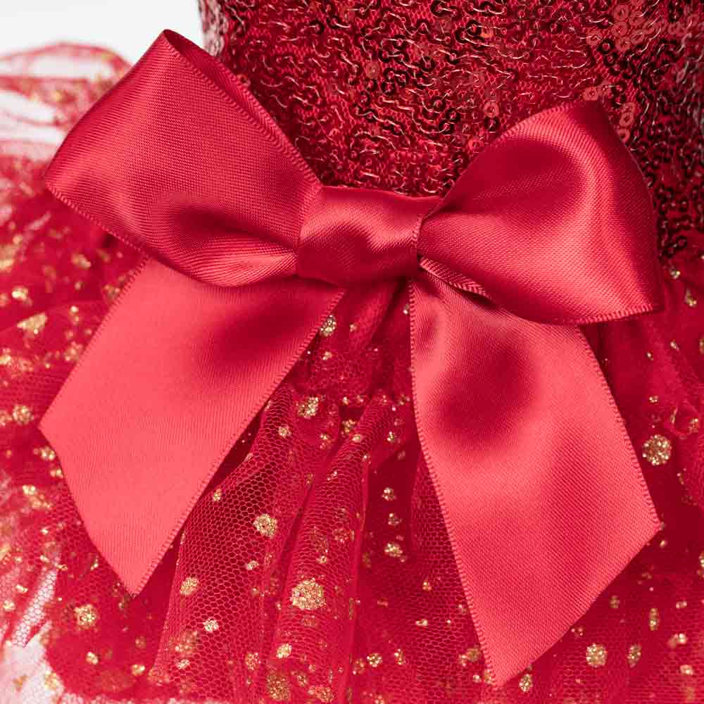 Close-up of red satin bow and glitter tulle skirt on a festive sequin dog dress.