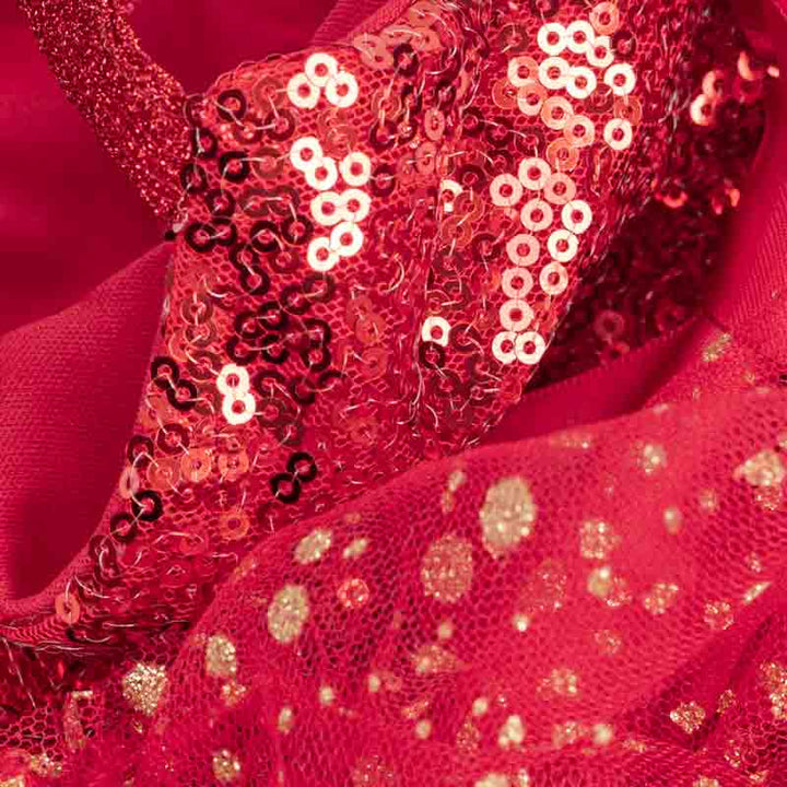 Detailed view of red sequin fabric and glitter mesh layers from a glamorous dog dress.
