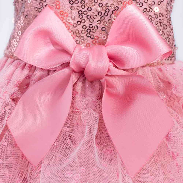 Close-up of pink satin bow and sparkly tulle layers from a sequin dog dress.