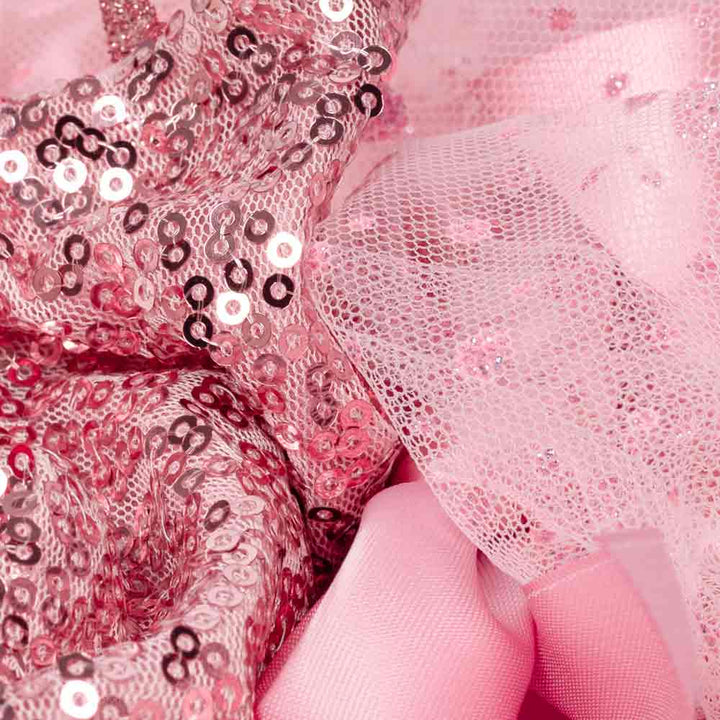 Detailed texture of pink sequin top and layered tulle skirt from a cute dog dress.