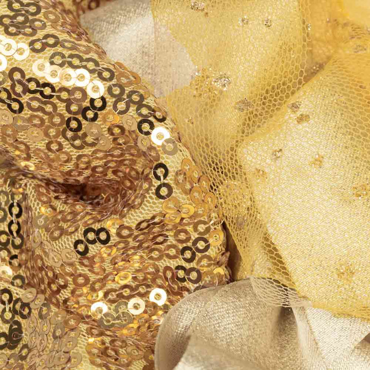 Detailed view of gold sequins and glitter tulle fabric from elegant dog pajamas.
