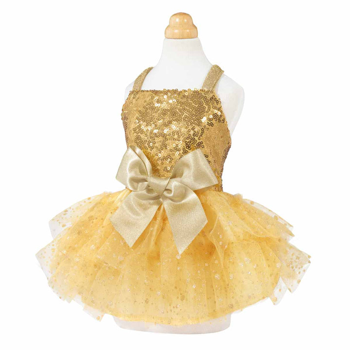 Side angle of gold sequin dog pajamas with elegant satin bow and shimmery tulle skirt.