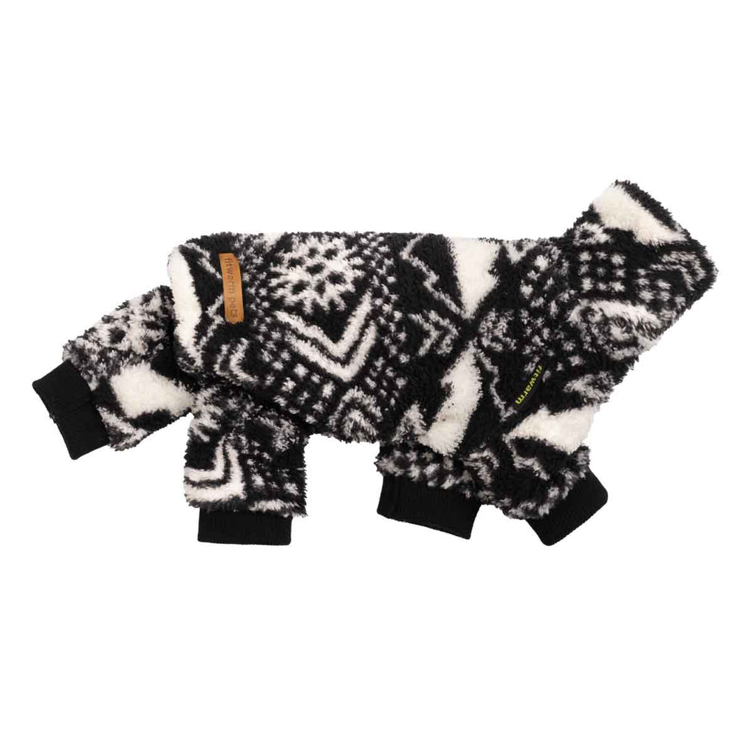 Side view of fuzzy geometric black and white dog pajamas with ribbed cuffs and full-body warmth.