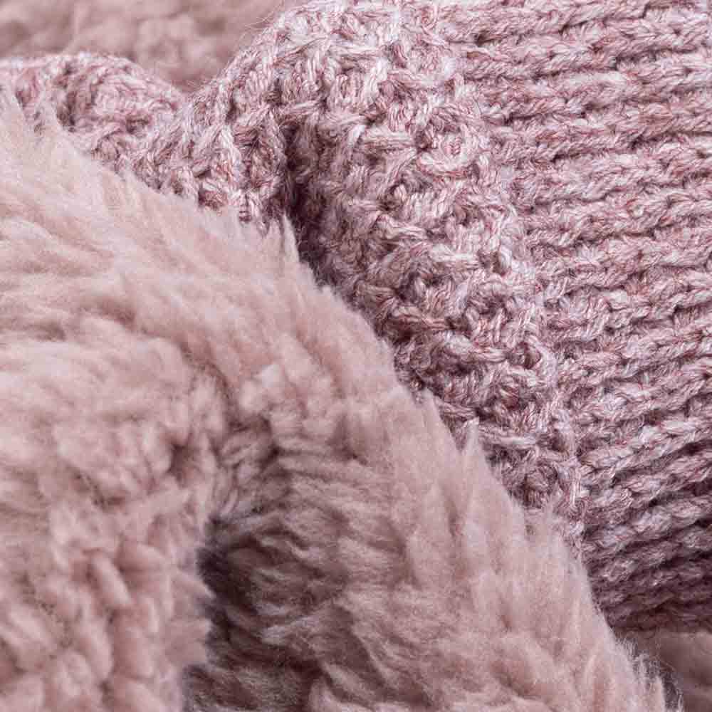 Close-up texture of mauve fleece and knit fabric used in cozy dog pajamas.