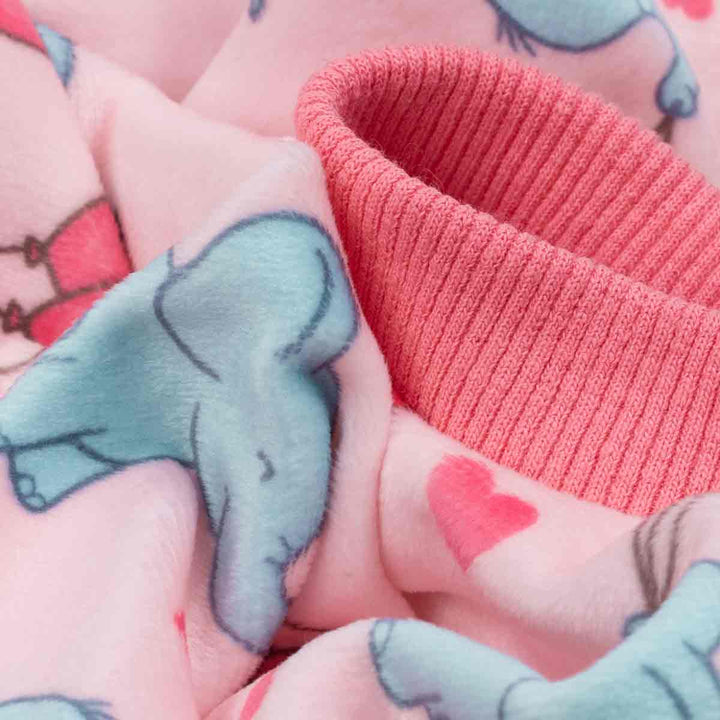 Close-up of pink dog pajamas fabric with blue elephants holding balloons and pink hearts, ribbed cuff.