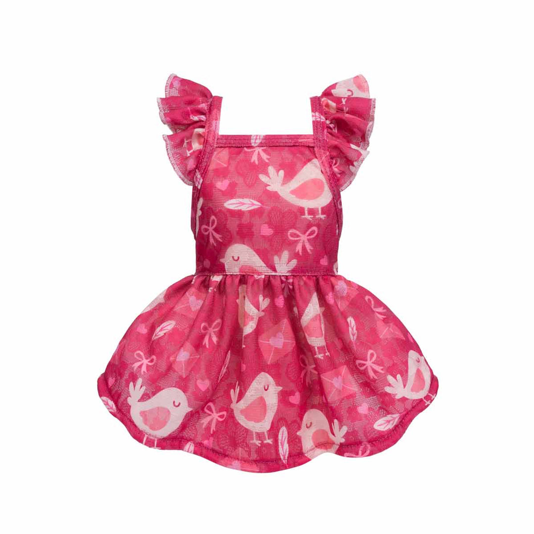 Pink ruffle dog dress with bird-print design displayed from the front.