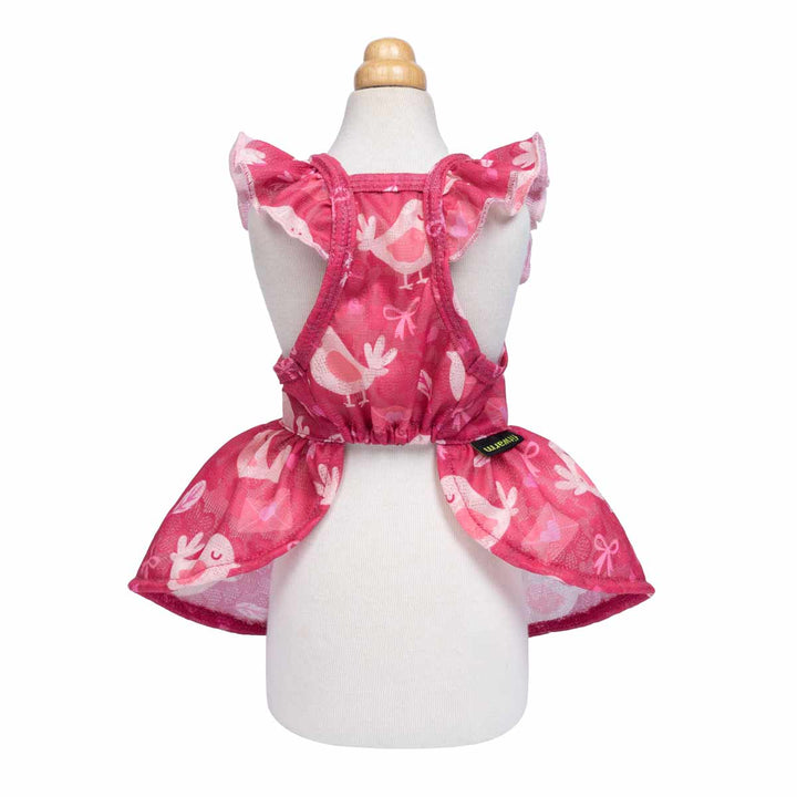 Pink bird-pattern dog dress with ruffle sleeves shown on a mannequin from the back.