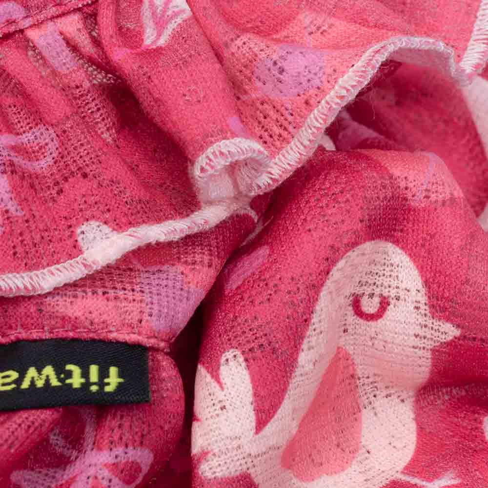 Close-up of the dog dress lace fabric showing pink bird patterns and soft textured stitching.