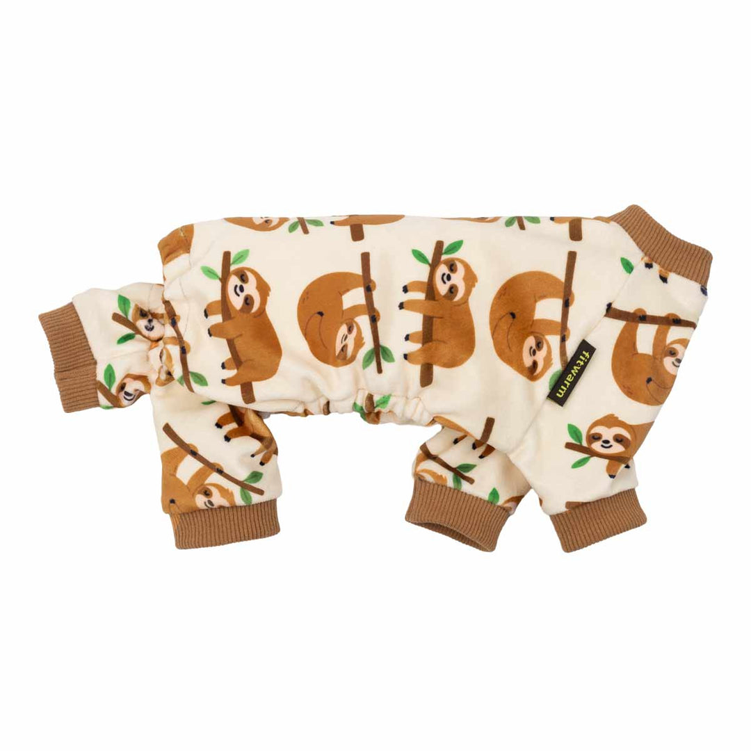 Side view of dog pajamas decorated with smiling sloth graphics on a cream background.