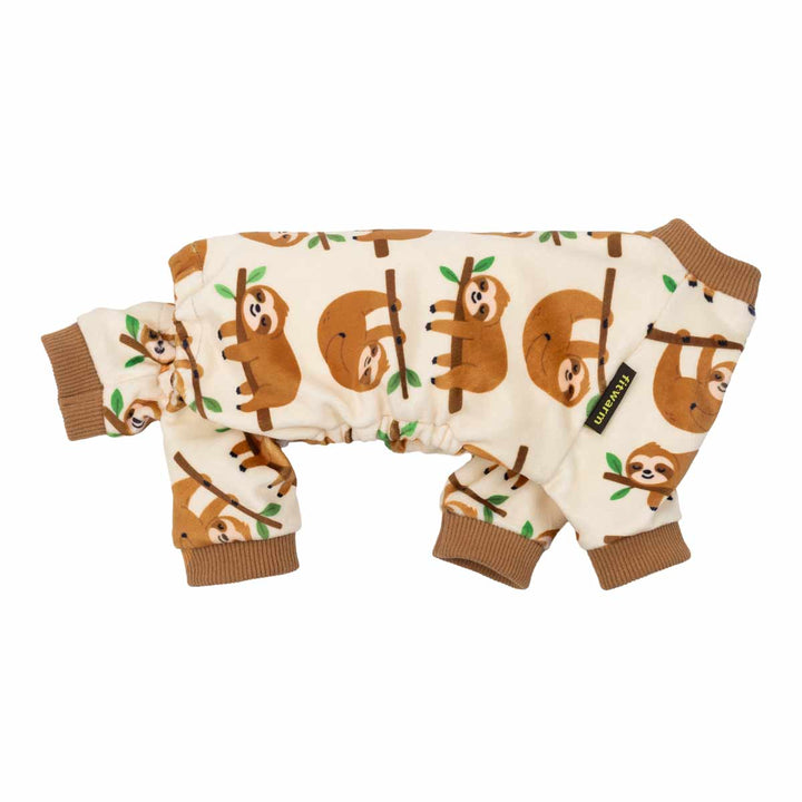 Side view of dog pajamas decorated with smiling sloth graphics on a cream background.