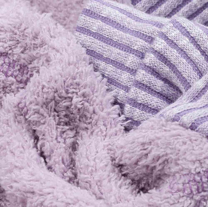 Close-up of lilac double face fleece and striped rib trim on cozy dog pajamas.