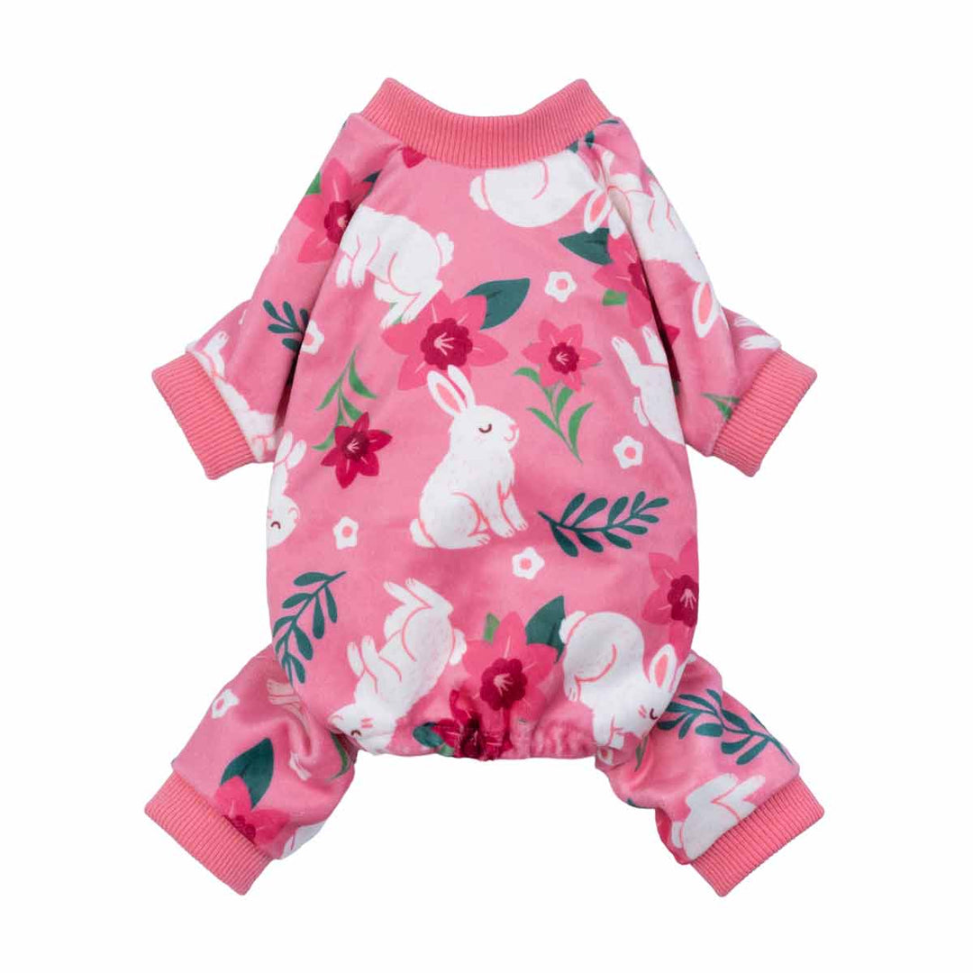 Pink dog pajamas featuring white bunnies and floral accents on a soft all-over print.