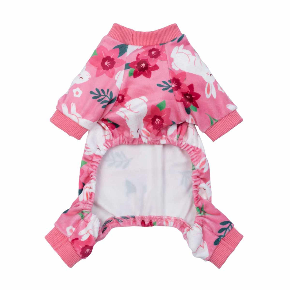 Pink dog pajamas with white bunny and floral prints shown from the underside for fit detail.