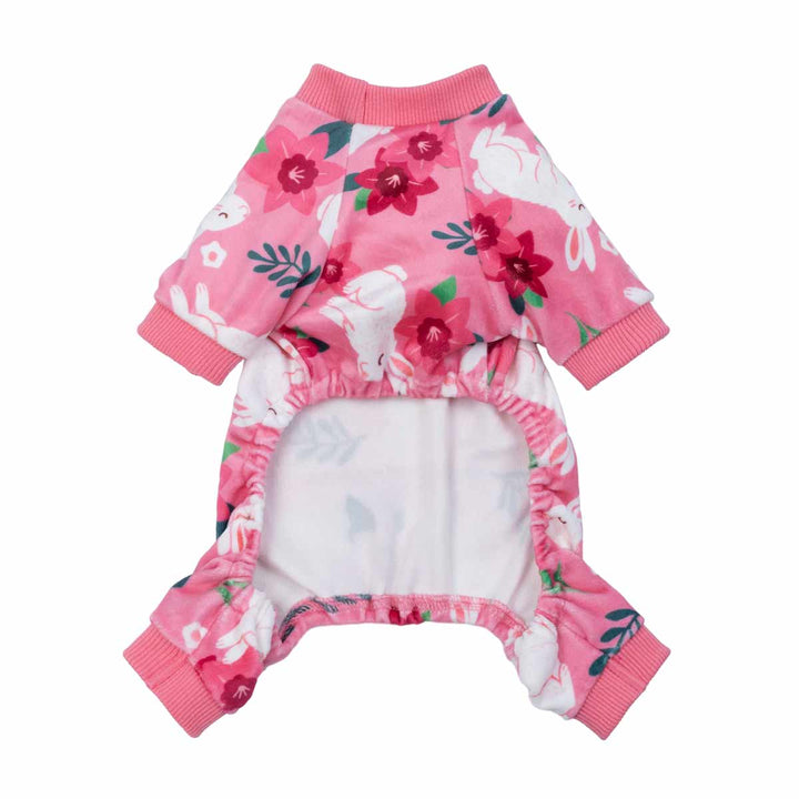 Pink dog pajamas with white bunny and floral prints shown from the underside for fit detail.