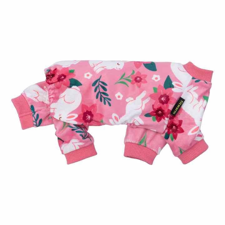 Side view of pink dog pajamas covered in white bunny motifs and vibrant floral patterns.