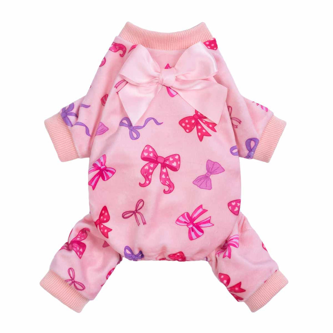 Pink dog pajamas featuring an allover bow pattern with a large satin bow detail on the back.