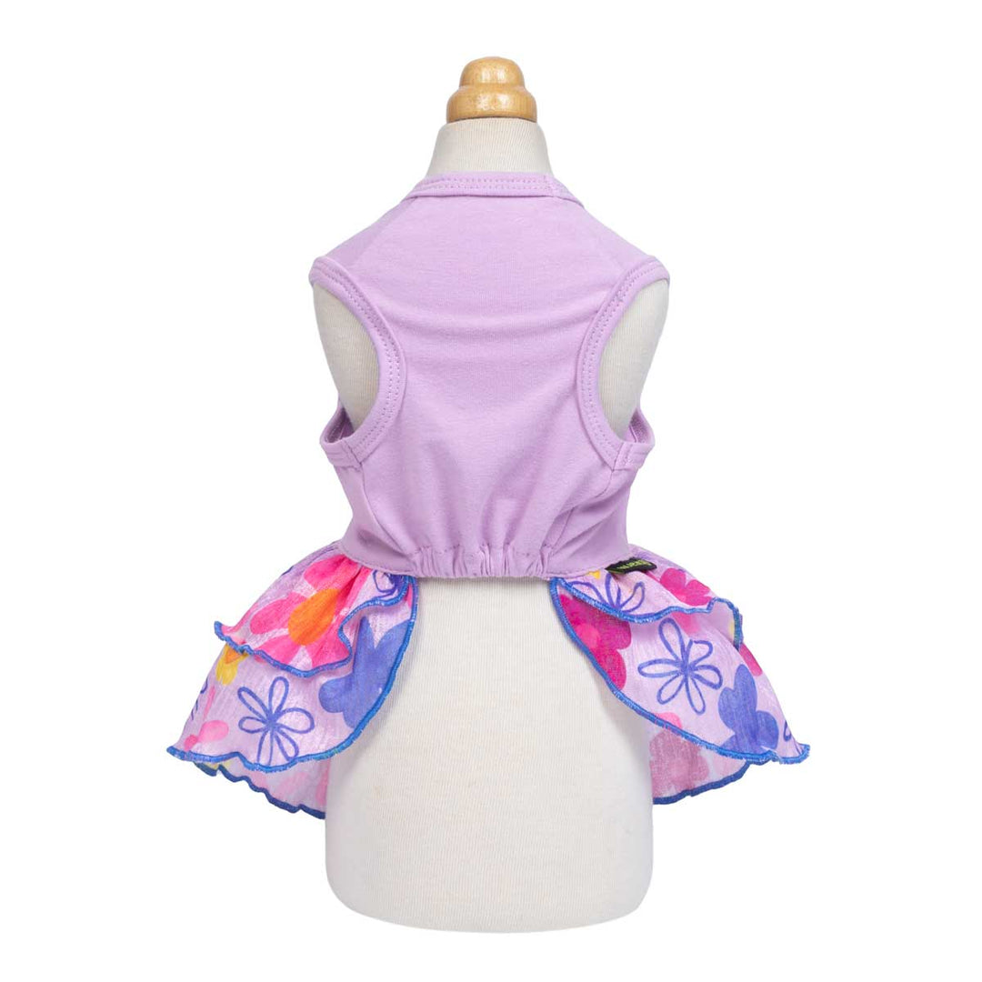 Back view of purple floral dog dress with layered ruffle skirt and sleeveless design.