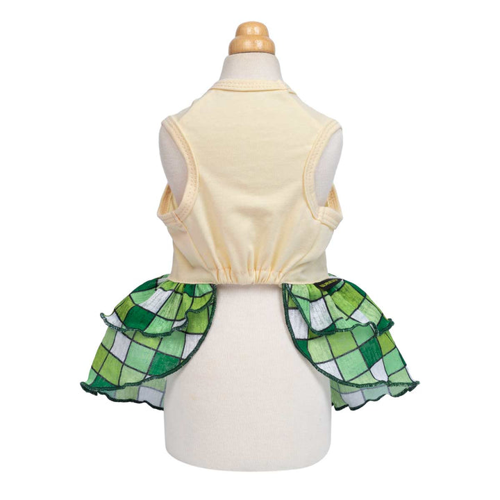 Back view of dog dress showing sleeveless cream top and flowy green plaid ruffle skirt design.
