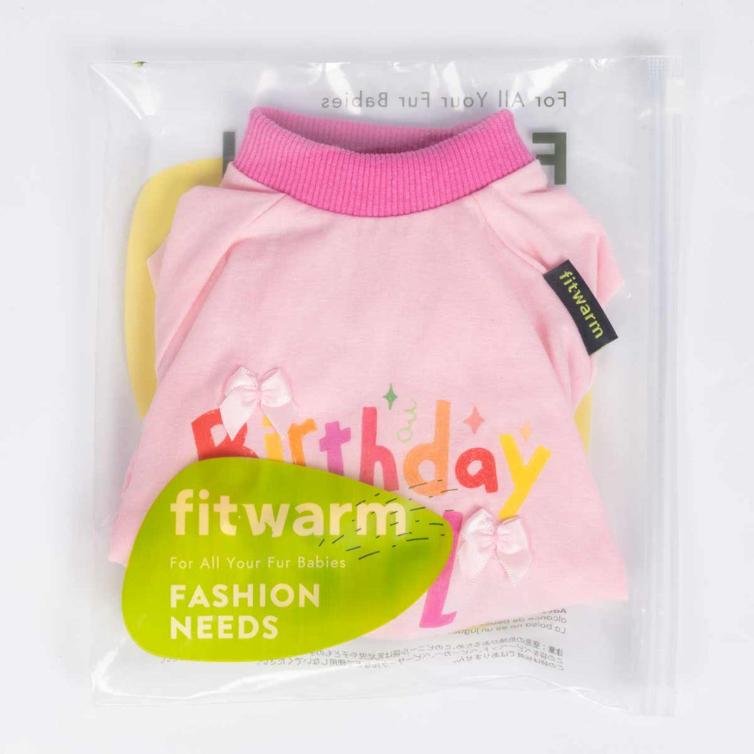 Pink birthday dog pajamas neatly folded inside clear Fitwarm packaging with brand label.