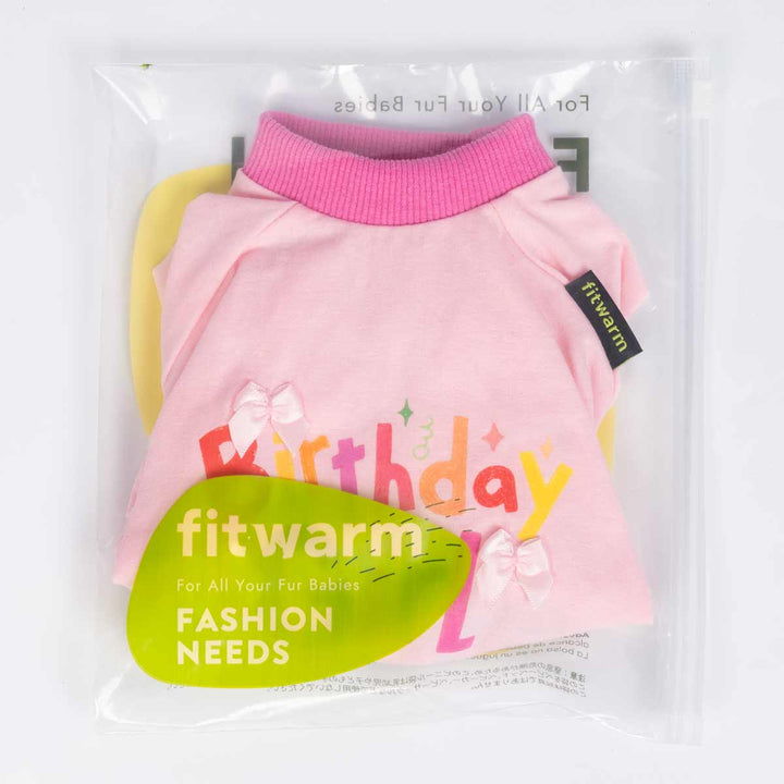 Pink birthday dog pajamas neatly folded inside clear Fitwarm packaging with brand label.