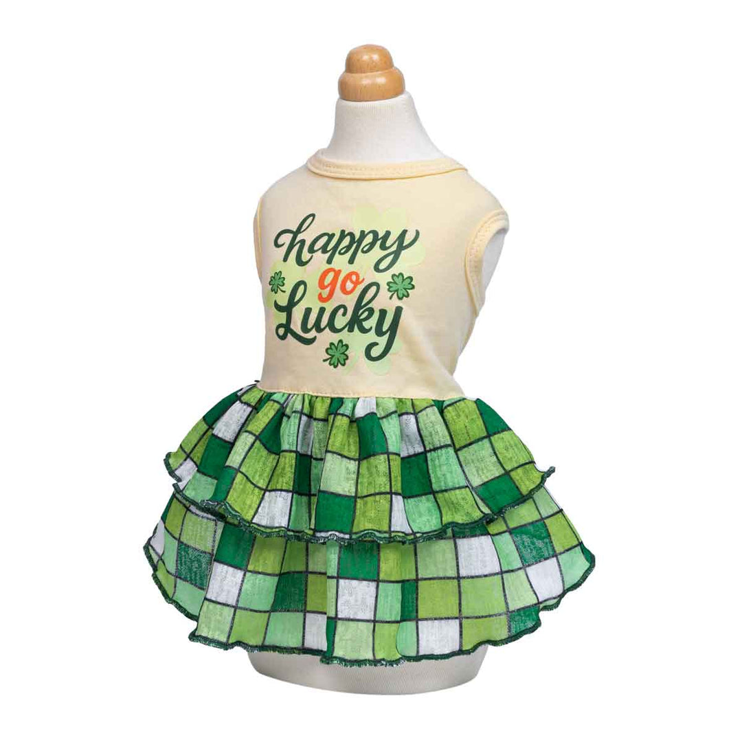 Mannequin wearing a St. Patrick’s Day inspired dog dress with clover text and tiered green skirt.