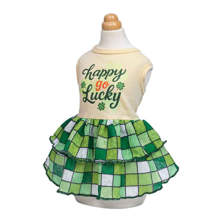 Mannequin wearing a St. Patrick’s Day inspired dog dress with clover text and tiered green skirt.