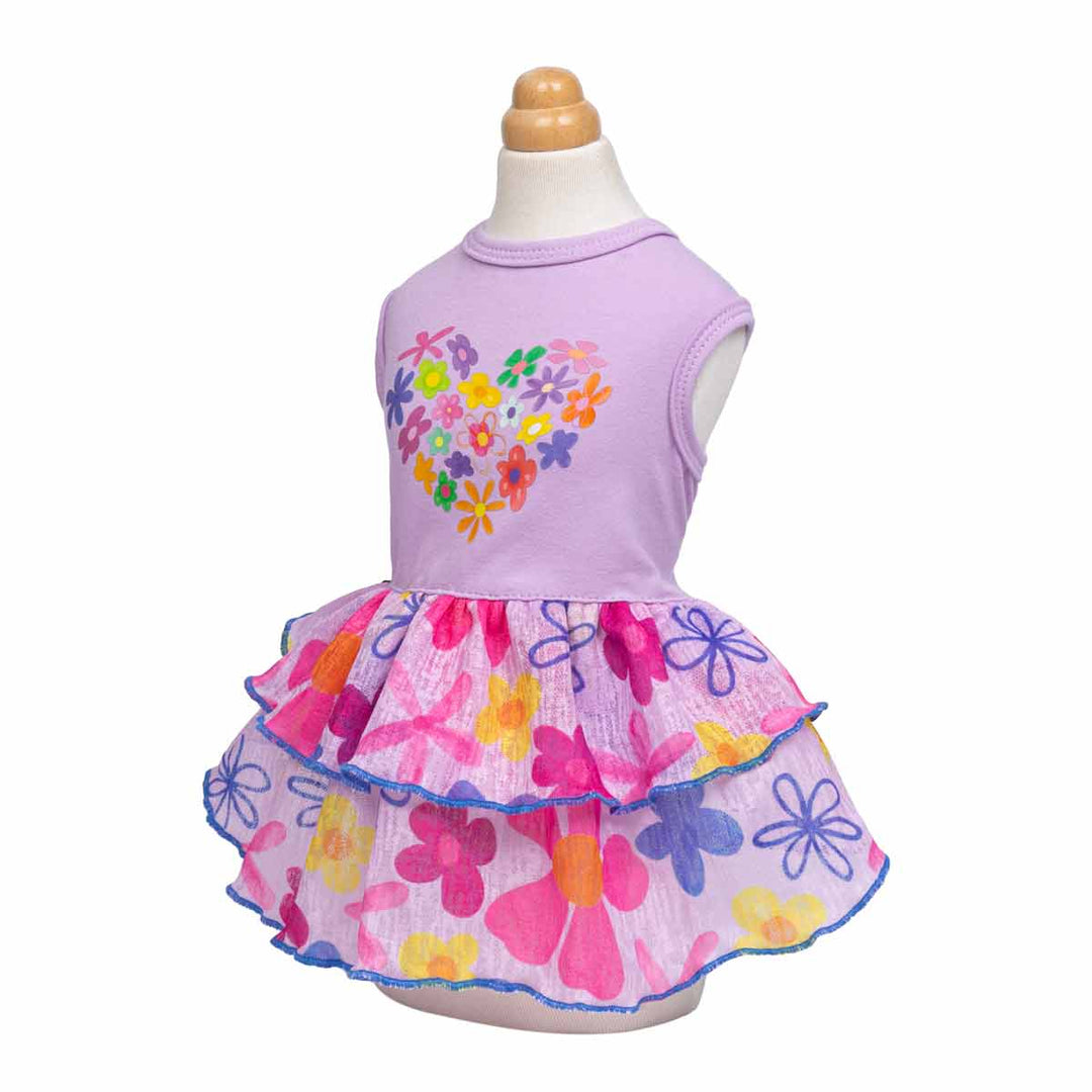Side view of purple dog dress featuring colorful flower prints and tiered ruffle skirt.