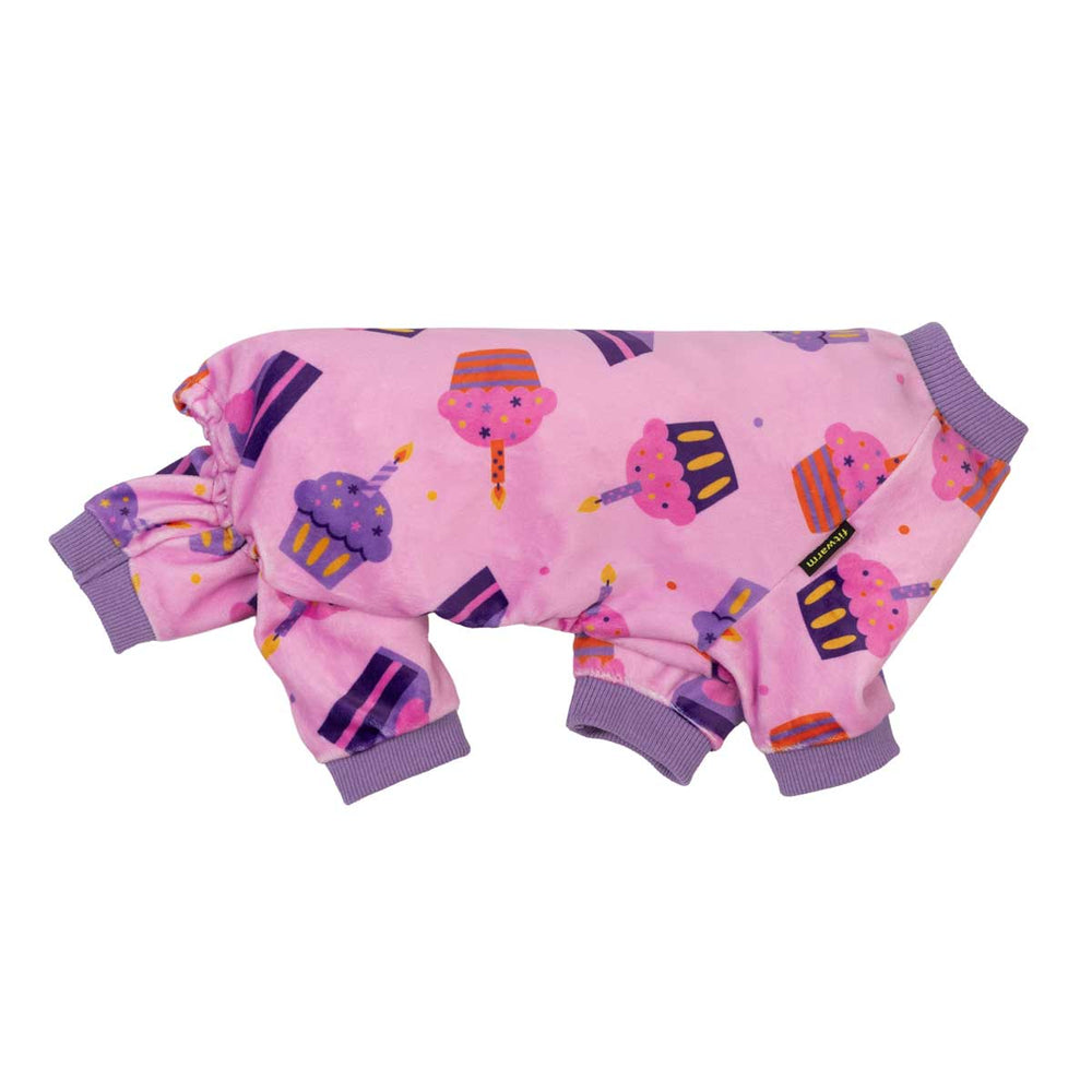 Side view of birthday dog onesie with cake prints on a white background